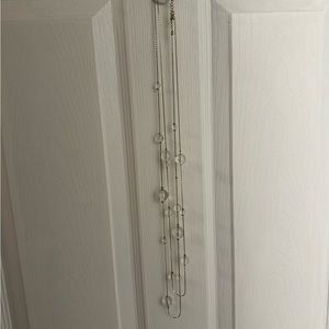 Long gold colored necklace with little crystal balls